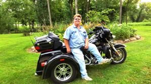 Sam in front of Trike Small.jpg Sam in front of Trike Small.jpg