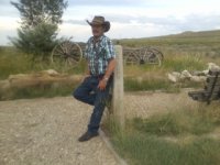 paul-leaning against the cross trails marker of the oregon, california, mormon and pony express .jpg