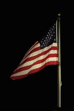 bright-american-flag-flying-high-in-night-darkened-sky-taya-johnston.jpg
